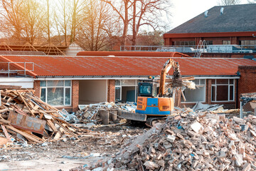Demolition of building. Excavator breaks old house. Making space for the construction of a new houses