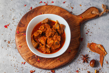 selective focus of delicious Indian style mutton curry with a decorative background. 