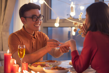 Young Asian couple eating dinner together