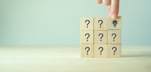 Question marks and light bulb symbolizing idea or solution. Problem solving skill, creativity,...