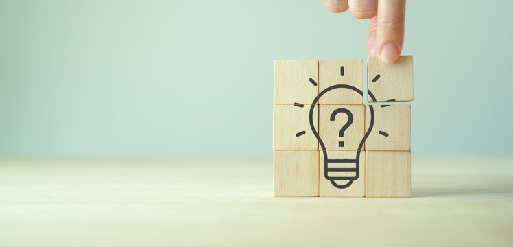 Question marks and light bulb symbolizing idea or solution. Problem solving skill, creativity, innovation, brainstorming, critical thinking and root cause analysis concept. Question, idea and answer.