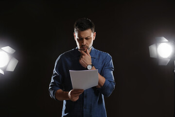 Professional actor reading his script during rehearsal in theatre