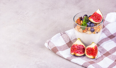 Homemade yogurt with berries and muesli. Yogurt and figs copy space