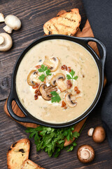 Mushroom champignon soup with bread and fresh mushrooms. top view , autumn seasonal cream soup with vegetables 