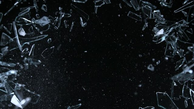 Super Slow Motion Shot of Glass Shards Flying Towards Camera Isolated on Black at 1000fps.