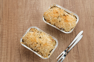 Baked Macaroni Schotel in an aluminium foil cup. 
