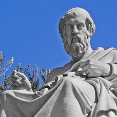 Plato, the ancient Greek philosopher marble statue deep in thought under clear blue sky, Athens,...
