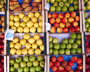Colorful apples and pears in the grocery store, geometric background with fresh fruits of the earth.