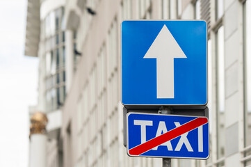 Traffic signs One Way Road and End Of Taxi Stand on city street, space for text