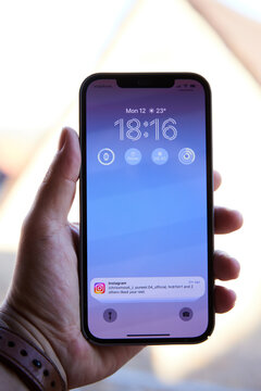 Close up of iPhone 12 Pro Max in Hand and Instagram Notification on Lock Screen