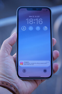Close up of iPhone 12 Pro Max in Hand and Instagram Notification on Lock Screen