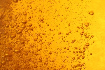 Tasty beer with bubbles as background, closeup