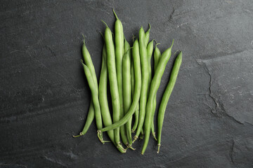 Fresh green beans on black table, flat lay