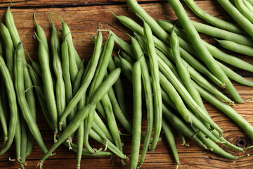 Fresh green beans on wooden table, flat lay