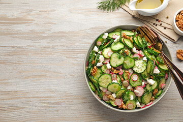 Delicious cucumber salad served on white wooden table, flat lay. Space for text