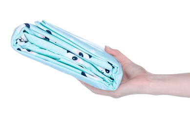 Folded baby bed linen in hand on white background isolation