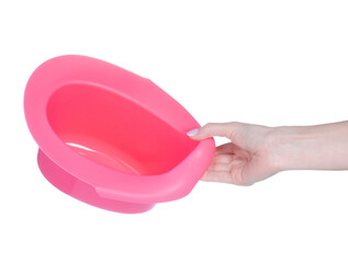 Baby pink potty in hand on white background isolation
