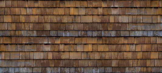 Old brown rustic dark wooden shingle wall facade texture - wood background textured pattern.