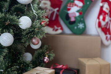 Festive Christmas decorations of a light room with a Christmas tree and knitted socks for Santa's gifts