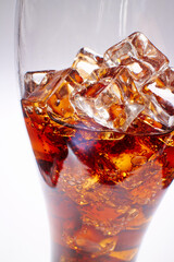cola with ice cubes on white