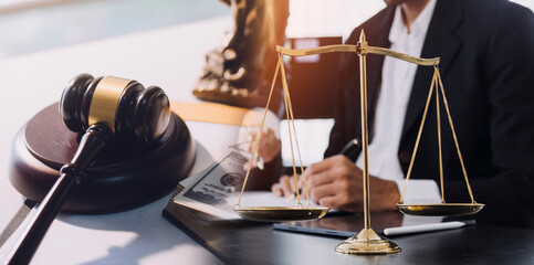 Business and lawyers discussing contract papers with brass scale on desk in office. Law, legal services, advice, justice and law concept picture with film grain effect