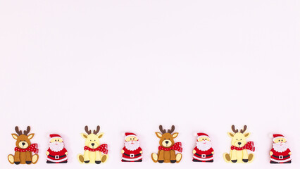 Little cute Santa Clous and reindeers on white copy space background. Flat lay