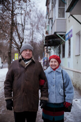 Portrait of  elderly man with  mature wife on  winter city street