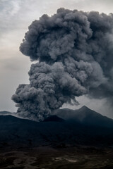 Fototapeta na wymiar Smoke and ash erupting from Mt Bromo summit
