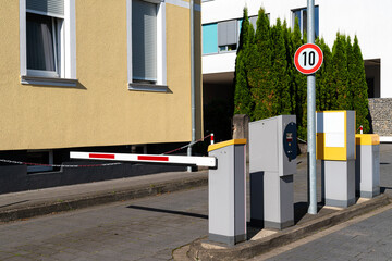 Barrier blocking the road to paid parking. Parking payment system.