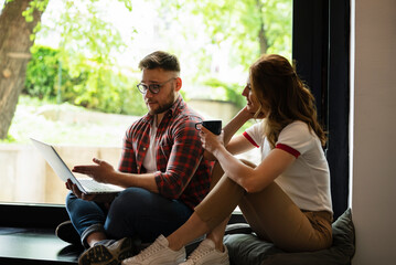 Young happy couple. Boyfriend and girlfriend drinking coffee together..