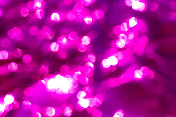 Beautiful abstract pattern with pink festive bokeh. Bright blurred background. Defocus texture of celebration glitter decor