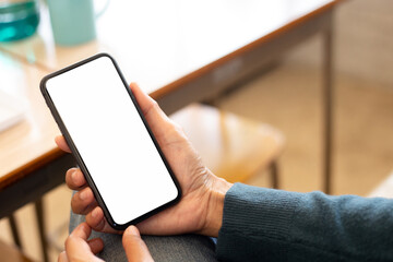 cell phone blank white screen mockup.hand holding texting using mobile on desk at office.background empty space for advertise.work people contact marketing business,technology