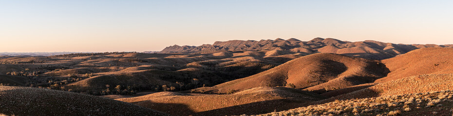 Ancient panoramic landscape, golden hour with rolling hills and light on the ranges. Outback South Australia.