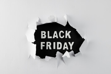 Composition of white paper card and black friday text