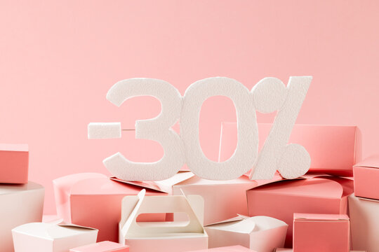 Composition of -30 percent with boxes on pink background