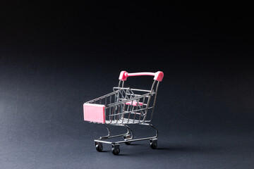 Composition of shopping cart and copy space on gray background