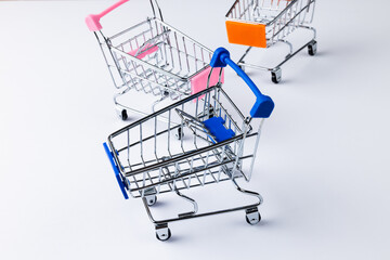 Composition of shopping carts and copy space on white background