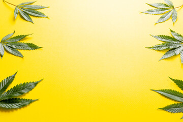 Fototapeta na wymiar Image of marihuana leaves lying on yellow background