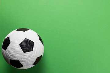 Composition of football on green background with copy space