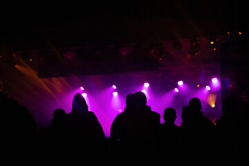 Fototapeta na wymiar Crowd at concert and blurred stage lights.