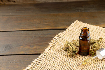 Image of cbd oil in bottle on wooden background