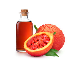 Gac fruit oil with fresh fruits isolated on white background.
