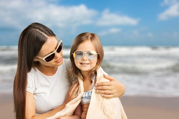 Shot of a woman spending the day at the beach with adorable child.