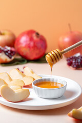 Closeup of plate with apples and honey for Jewish holiday Rosh Hashanah