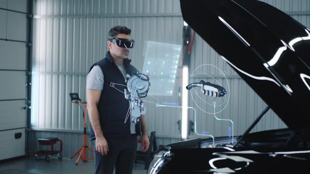 Car service manager conducts car diagnostics using holographic hud interfaces and vr headset. The specialist studies the serviceability of the engine and other parts of the car in 3D cyber space.