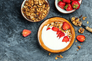 Granola with yogurt, honey and with strawberries. Delicious breakfast or snack. top view. place for text