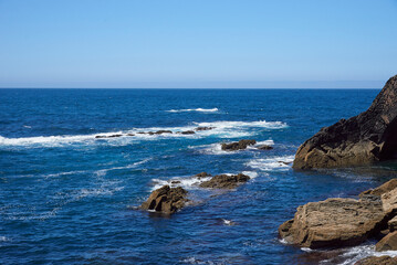 Luarca, Asturias, Spain; June 16, 2022; A beautiful sea view on the coast of Luarca.Cliffs of northern Spain.Lighthouse access to the port of Luarca, Asturias.