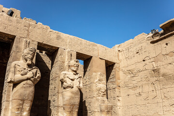 Statues of ancient Egyptian pharaohs and gods. Various hieroglyphs on the walls. Karnak temple is...