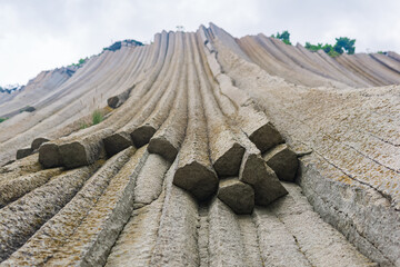 basalt columns forming a coastal rock at Cape Stolbchaty on Kunashir Island, close-up