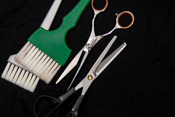 professional hairdressing tools are arranged on a dark background